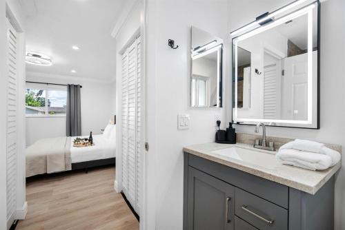 a bathroom with a sink and a bedroom with a bed at WOW! Pickleball - Gym - Stylish Modern Living in Valrico