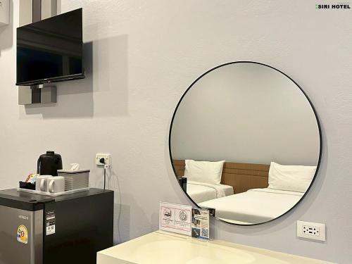 a mirror in the corner of a room at Siri Hotel Phuket in Phuket Town