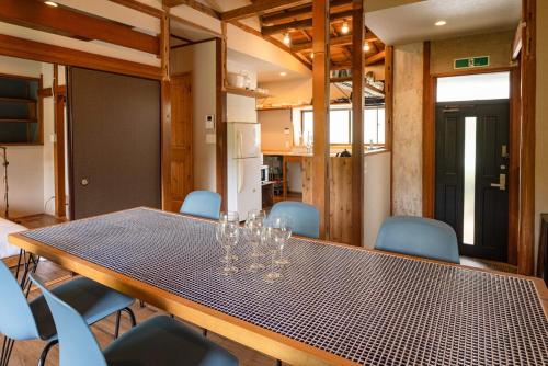 a dining room with a table and blue chairs at 伊東市貸切一軒家 in Ito