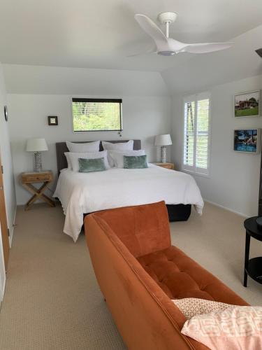 a bedroom with a large bed and a couch at Forty9 Steps in Russell