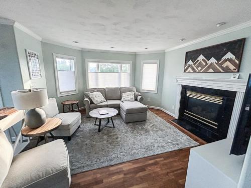 a living room with a couch and a fireplace at 3BR - Near Mt Massive & Mt Sherman Escape in Leadville