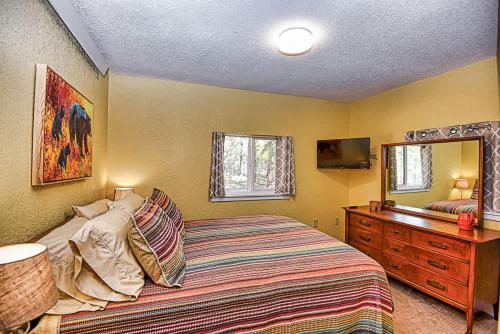 a bedroom with a bed and a dresser and a mirror at New Listing 3bd Woodsy Vibe in Leadville in Leadville
