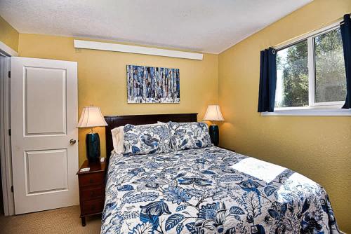 a bedroom with a bed and two lamps and a window at New Listing 3bd Woodsy Vibe in Leadville in Leadville