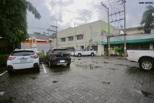 a group of cars parked in a parking lot at Siri Hotel Phuket in Phuket Town