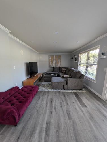 a living room with a couch and a table at CulDeSec Home 4BR 3 Half Baths Sleeps 7 Jacuzzi tub in Columbus
