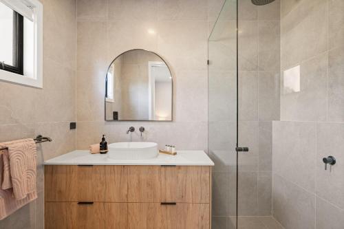 a bathroom with a sink and a shower at San Remo Luxe 2 in San Remo