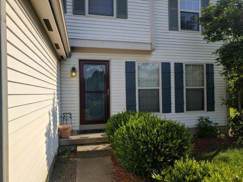 a white house with a door and a porch at CulDeSec Home 4BR 3 Half Baths Sleeps 7 Jacuzzi tub in Columbus