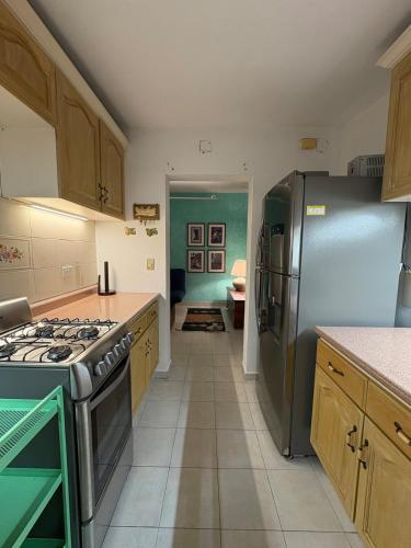 a kitchen with a stove and a refrigerator at Fun House Tampiquito in Monterrey