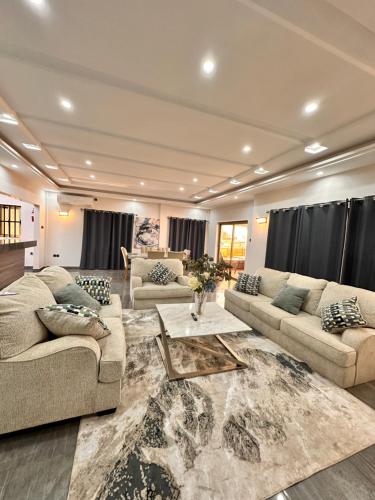 a living room with two couches and a table at Amina luxury suites in Lomé