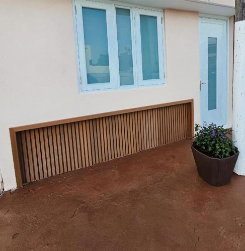 a house with a window and a plant in a pot at Blue Star Studio in Tierras Nuevas Poniente