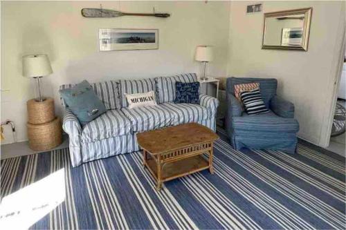 a living room with a couch and two chairs at Cottage Apartment by Lake MI w private Hot Tub! 