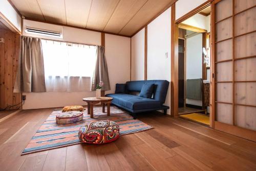 a living room with a blue couch and a table at yogahouse in Mine