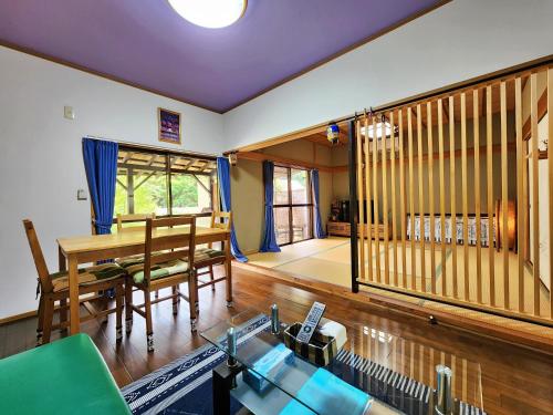 a living room with a table and a dining room at なごみの里 in Shionoe