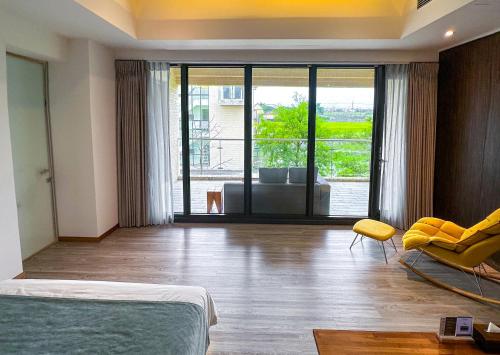 a bedroom with a bed and a chair and a couch at Villa LOHERB in Dongshan