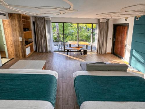 a hotel room with two beds and a balcony at Villa LOHERB in Dongshan