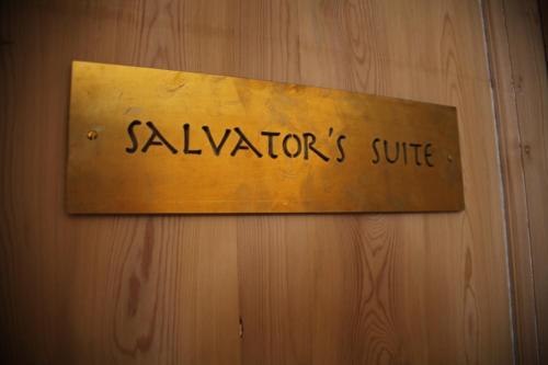 a sign on a wooden wall that reads navagrahas suite at B&B 1669 in Bruges