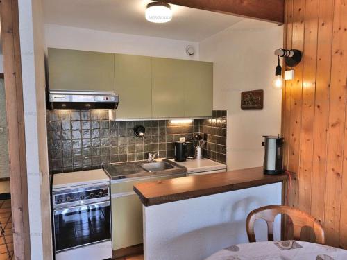 a kitchen with a sink and a stove at Charmant studio 4 pers. au Grand-Bornand, centre du village - FR-1-458-254 in Le Grand-Bornand
