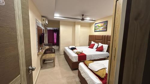 a hotel room with two beds and a bathroom at hotel KGB Legend Grand in Visakhapatnam