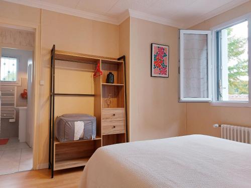 a bedroom with a bed and a book shelf at Gîte Saint Lubin à Cloyes : Confort familial et charme régional - FR-1-581-157 in Cloyes-sur-le-Loir