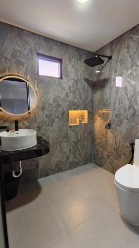 a bathroom with a sink and a toilet at Villa Dalia Puncak ACC9-18 in Cikujang
