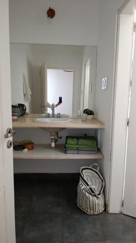a bathroom with a sink and a mirror at Posada El Descanso in Mercedes