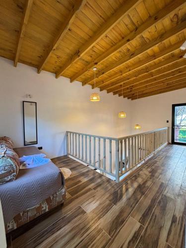 a bedroom with a bed and a wooden floor at Complejos Del Jaguel in Santa Teresita