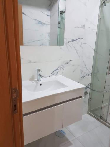 a white bathroom with a sink and a mirror at Levy-Cardoso Apartment in Praia