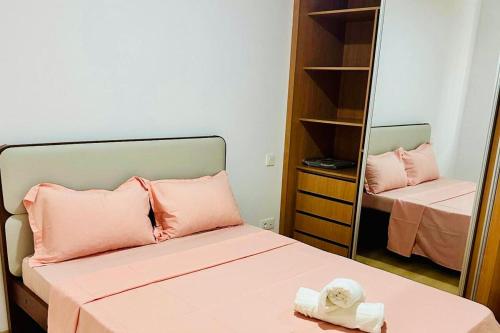 a small room with a bed and a mirror at Levy-Cardoso Apartment in Praia