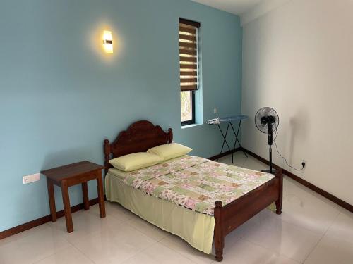 a bedroom with a bed and a table in it at Hilltop Retreat near Kandy Lake - Kings Residence in Kandy