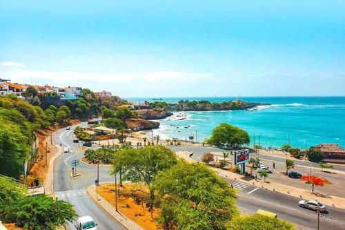 a view of a city with the ocean and a street at Levy-Cardoso Apartment in Praia