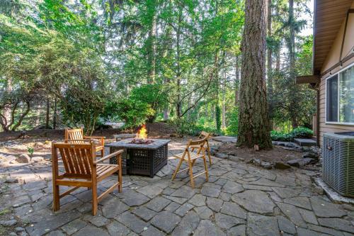 a patio with two chairs and a fire pit at Bellevue Forest Haven Hideaway in Bellevue