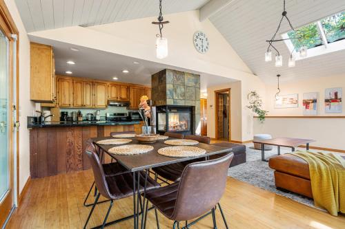 a kitchen and living room with a table and chairs at Bellevue Forest Haven Hideaway in Bellevue