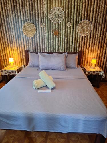 a bed with two pillows on it in a room at Casas de Ruumar Bed and Breakfast-Bar-Two rooms for family available in Clarin