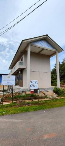 a building with a sign in front of it at Homestay Kg Razali in Kuantan