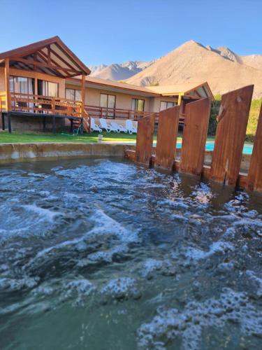 a pool of water in front of a house at Luna en San Isidro 
