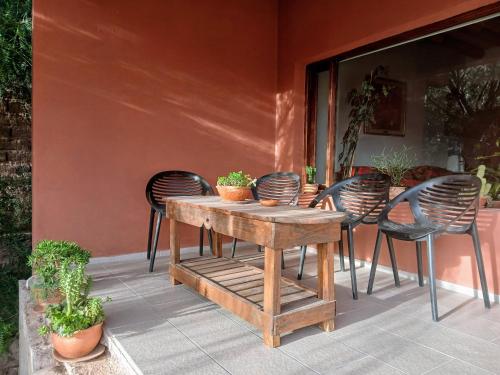 a wooden table and chairs on a patio at Guasamayo in Tilcara