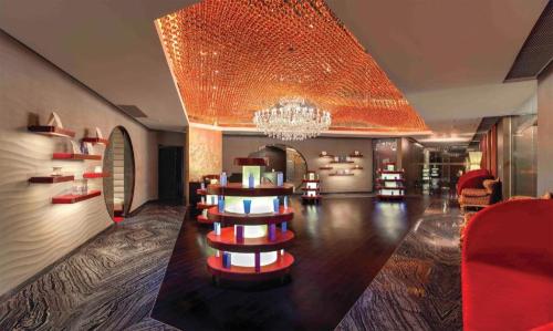 a large room with a chandelier and a table with books at Grand Lisboa Macau in Macau