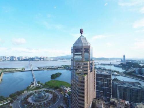 a tall building with a cross on the top of it at Grand Lisboa Macau in Macau