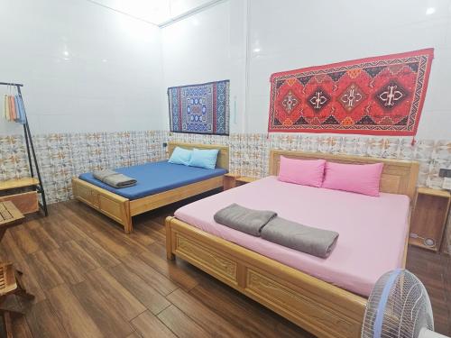 a bedroom with two twin beds and a mattress at Homestay Khoa Chaudoc in Chau Doc
