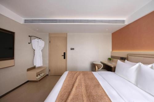 a hotel room with a large bed and a sink at Immersing Hotel Guilin Two Rivers and Four Lakes Dongxi Alley in Guilin