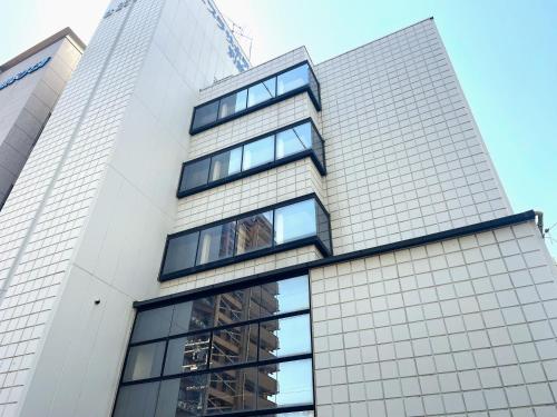 a tall white building with many windows at Matsue Plaza Hotel Annex in Matsue