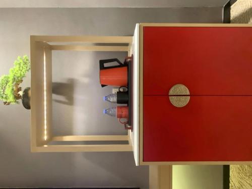 a red cupboard with a red door and a drawer at E-Cheng Hotel Yangjiang Baili Plaza in Yangjiang