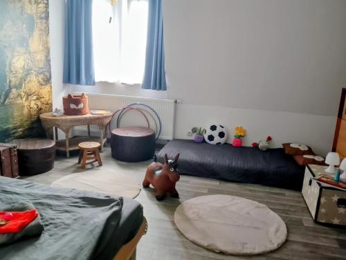a room with a bed and toys in it at Nähe Plohn Park - FEWO mit Spielzimmer und Balkon, DZ in Auerbach