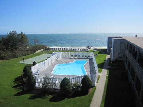 an overhead view of a swimming pool next to the ocean at Surfcomber On The Ocean in South Yarmouth