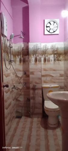 a bathroom with a shower and a toilet and a sink at Dinu Homes Stay in Haputale