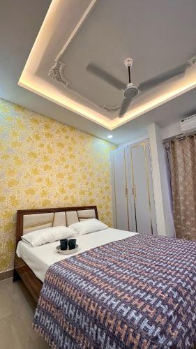 a bedroom with a bed and a ceiling at NIRA Luxe stay in Lucknow