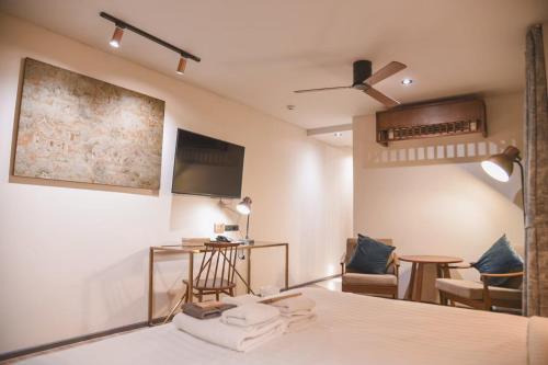a room with a bed and a flat screen tv at Gategaa Village in Chiang Mai