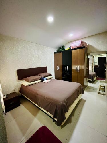 a bedroom with a large bed and a dresser at Moderno departamento en el corazón de la ciudad in Trinidad