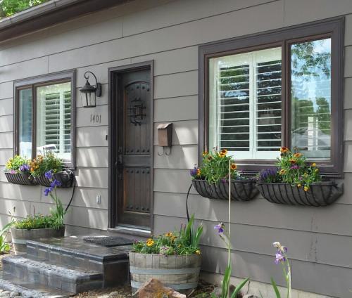 a house with three flower pots on the side of it at Yellowstone House of the Three Bears 2 Blocks to Downtown in Cody