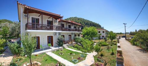 a house with a garden in front of it at Sklavos Studios in Neo Klima